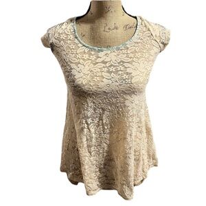 Day trip cream lace sheer top with teal ribbon ties on the back.